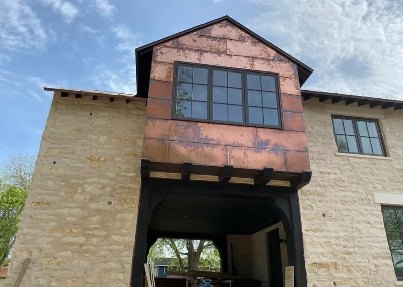 Copper metal panel facade on a stone building for Skylight Installation in Oldsmar